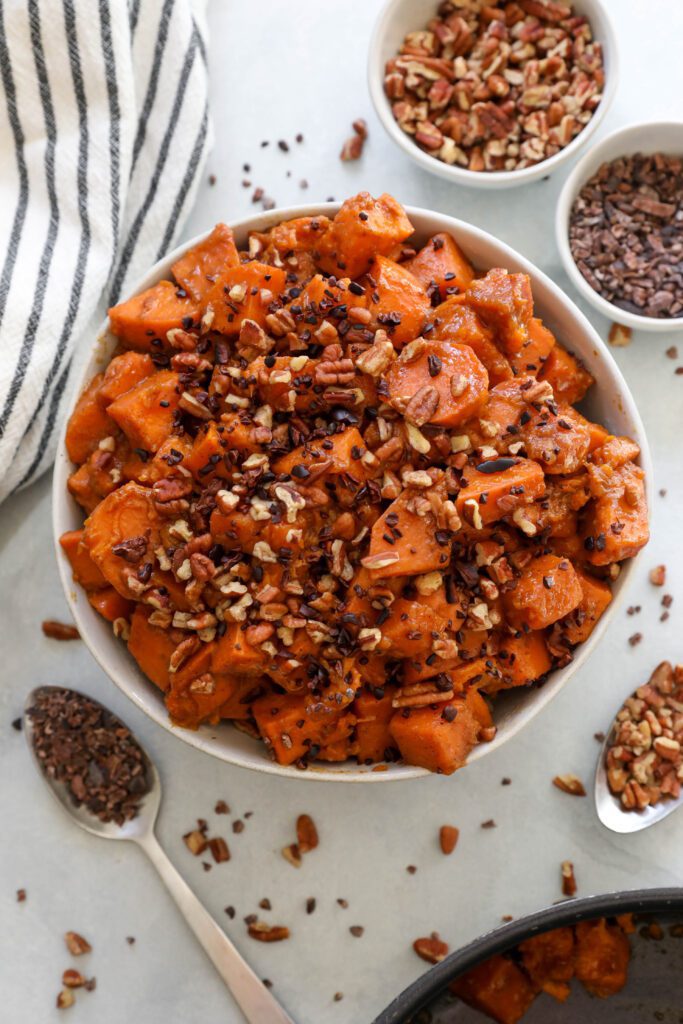 Candied Yams served in bowl with Cacao Nibs and Pecans by Flora & Vino