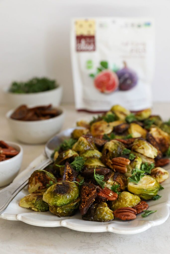 Roasted Brussels Sprouts served on platter with Figs & Pecans by Flora & Vino