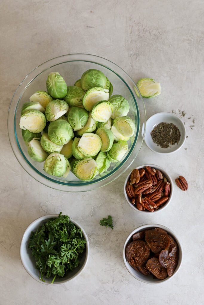 brussels sprouts, dill, figs, and pecans in bowls by Flora & Vino