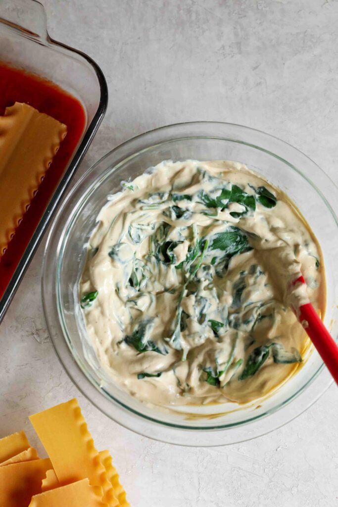 Tofu Ricotta in mixing bowl with spinach by Flora & Vino