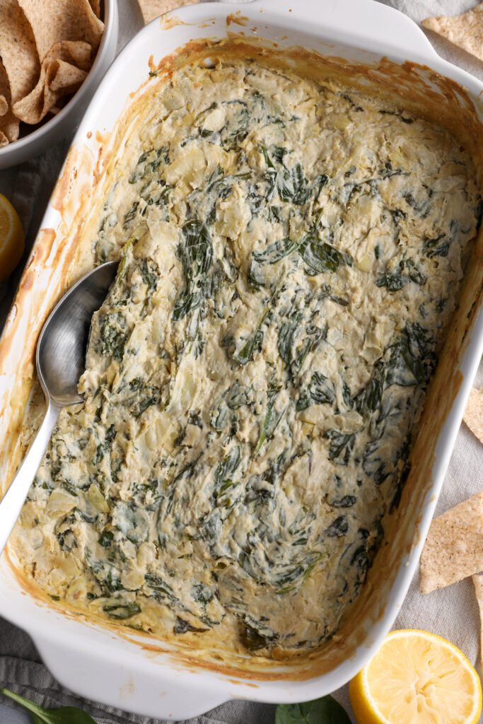 Spinach Artichoke Cashew Dip baked in dish by Flora & Vino