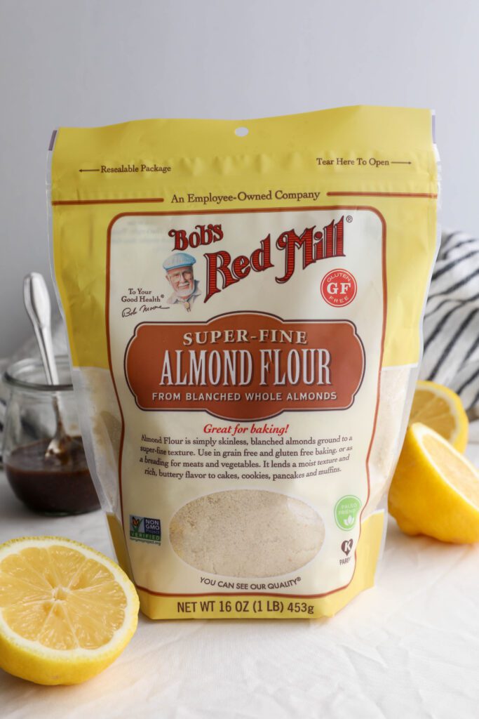 Bob's Red Mill Super-Fine Almond Flour in bag with halved lemons and jam with blue and white striped towel 