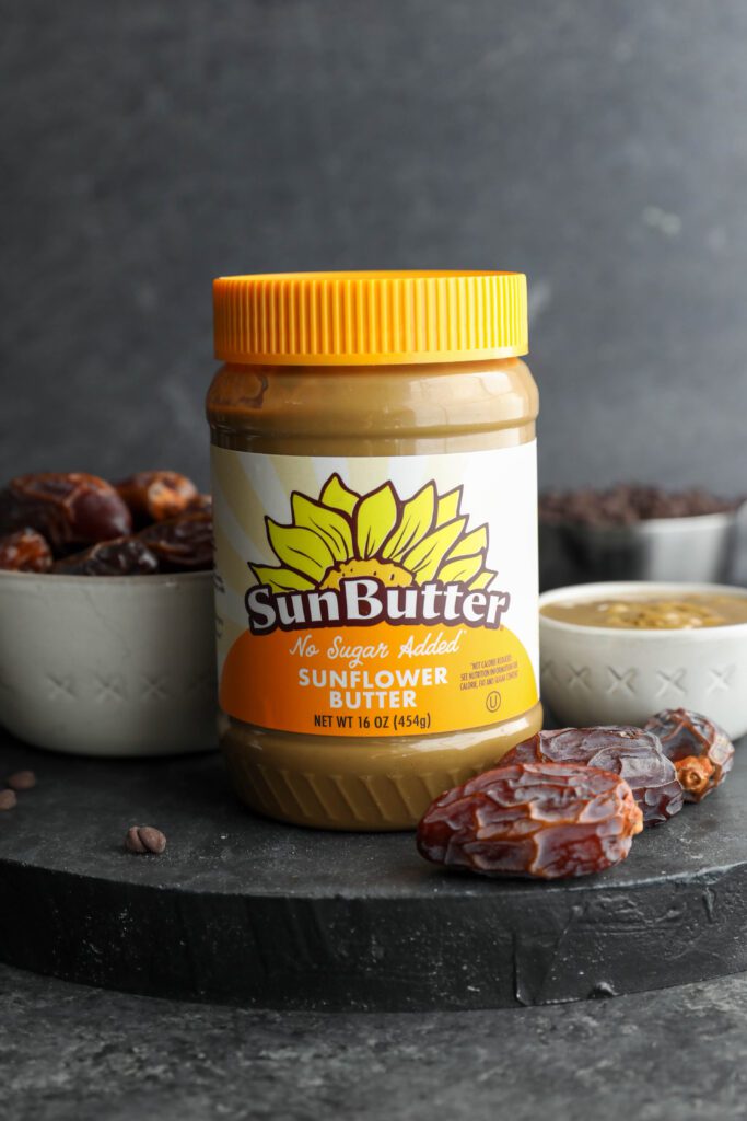 No-Sugar-Added SunButter with dates on wooden board by Flora & Vino