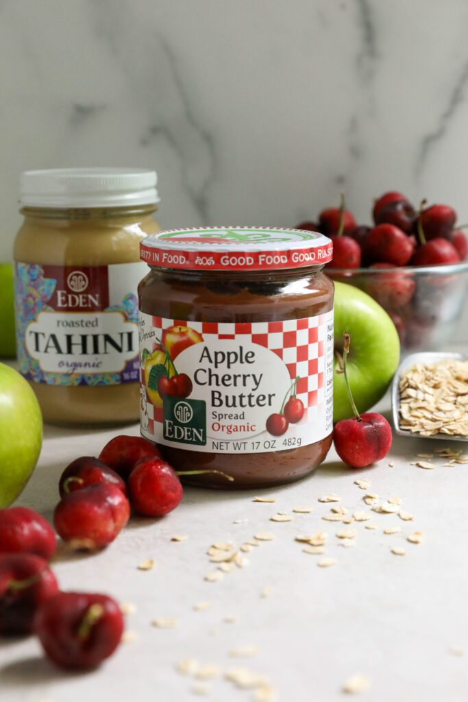 Apple Cherry Butter and Tahini on board surrounded by cherries and apples