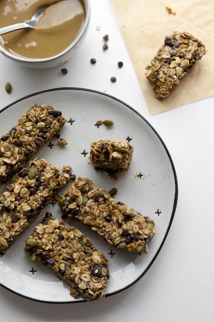 bite out of one Nut-Free SunButter Granola Bars on plate by Flora & Vino