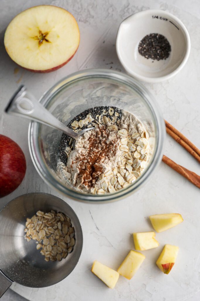 overnight oats mixed in mason jar with diced apples and oats and chia seeds by Flora & Vino