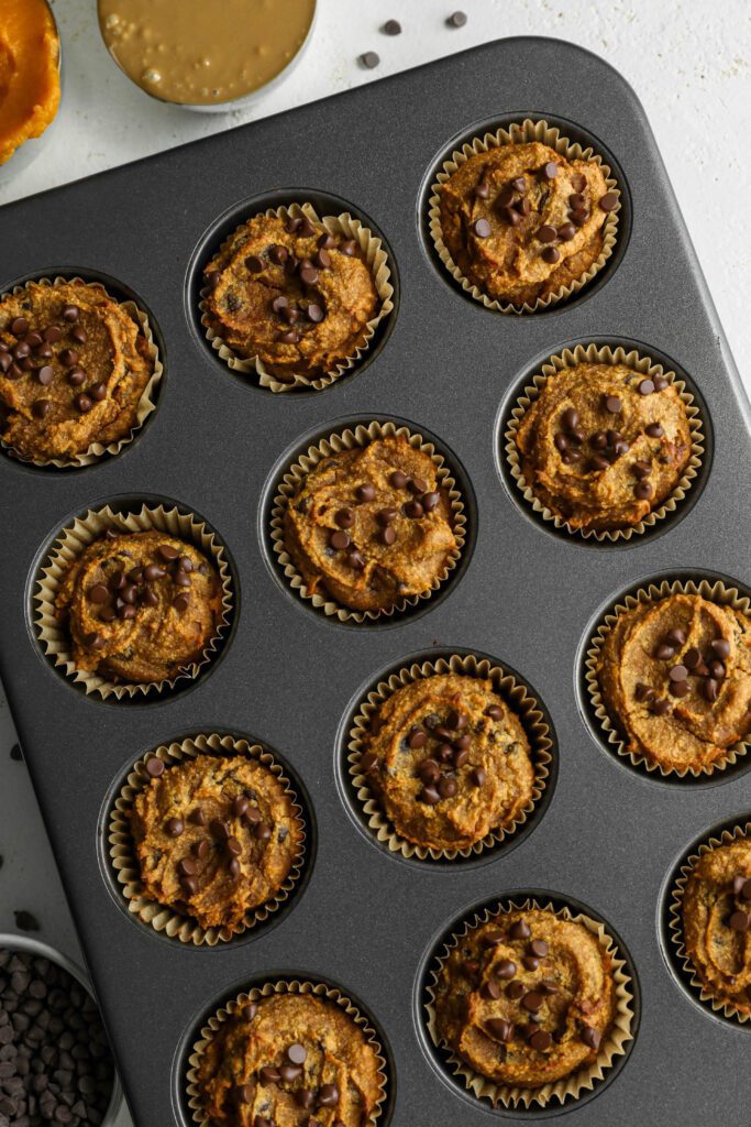 Pumpkin SunButter Chocolate Chip Muffins baked in muffin tin by Flora & Vino