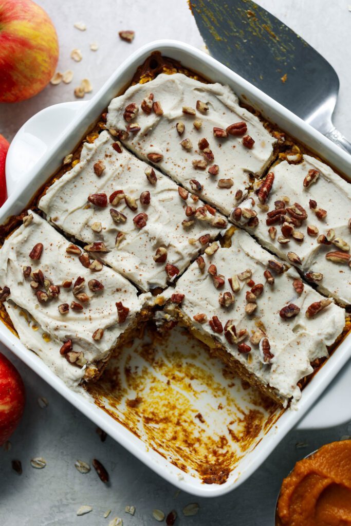 Pumpkin Apple Baked Oats sliced in square baking dish with one piece missing by Flora & Vino