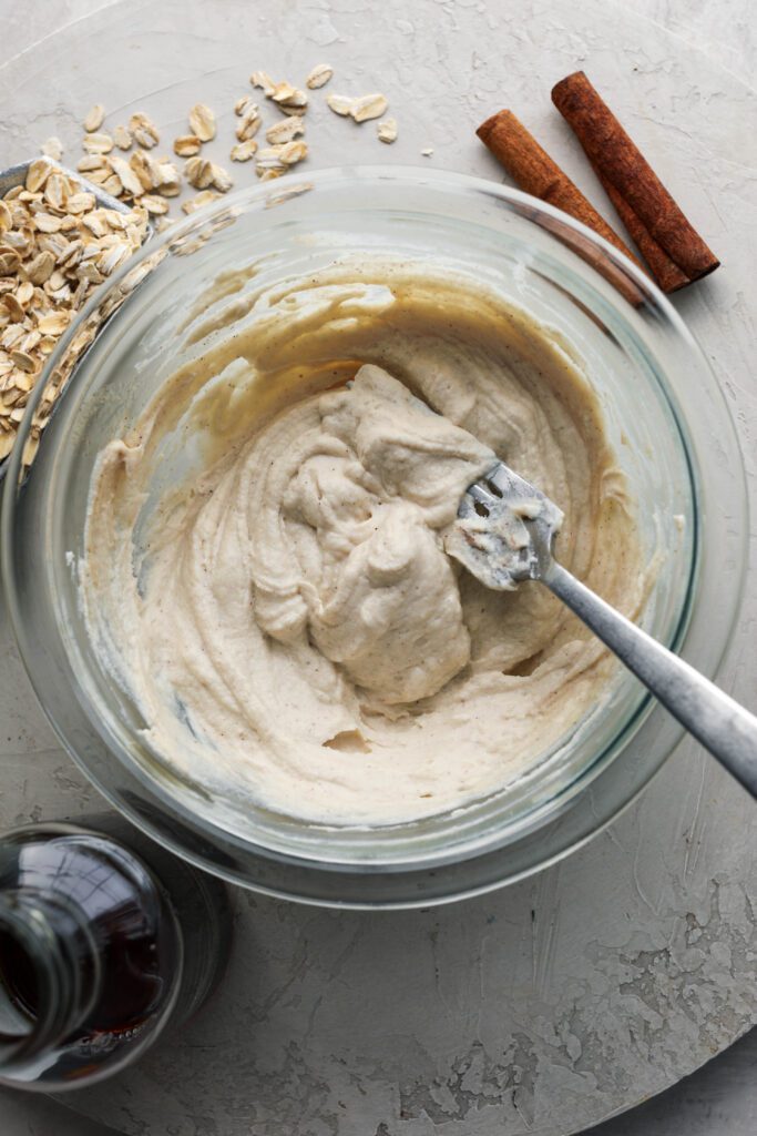 maple cream cheese frosting mixed up in glass bowl by Flora & Vino