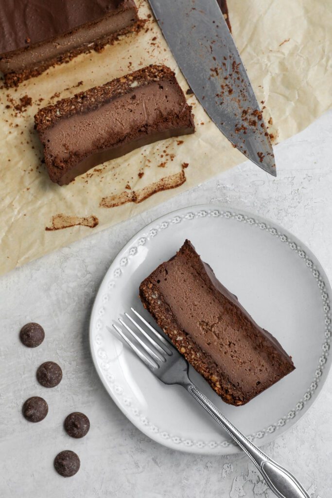 Vegan Chocolate Cheesecake sliced and served on a plate by Flora & Vino