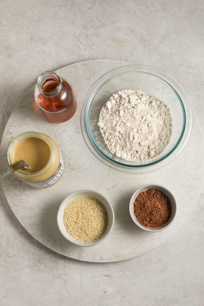 oat flour, maple syrup, Eden Foods tahini, sesame seeds, and cacao powder on wooden board by Flora & Vino