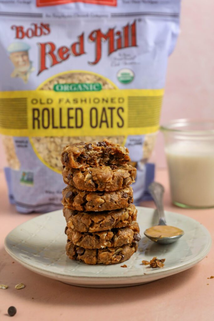 Peanut Butter Chocolate Chip Oatmeal Cookies stacked with Bob's Red Mill Organic Old Fashioned Rolled Oats by Flora & Vino