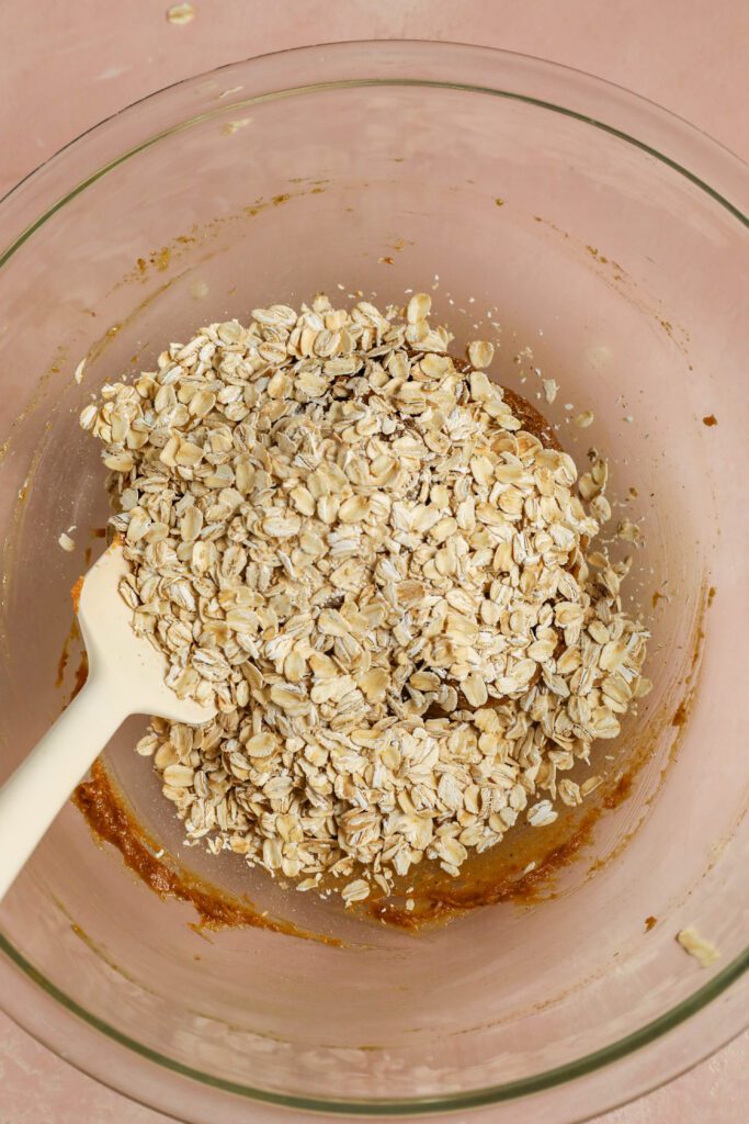 peanut butter cookie dough with oats in a bowl and spatula by Flora & Vino