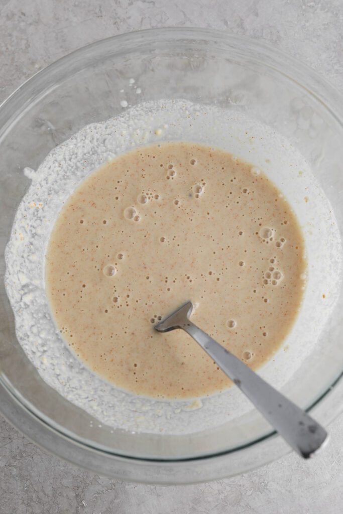 breading for cauliflower mixed in glass bowl with a fork by Flora & Vino