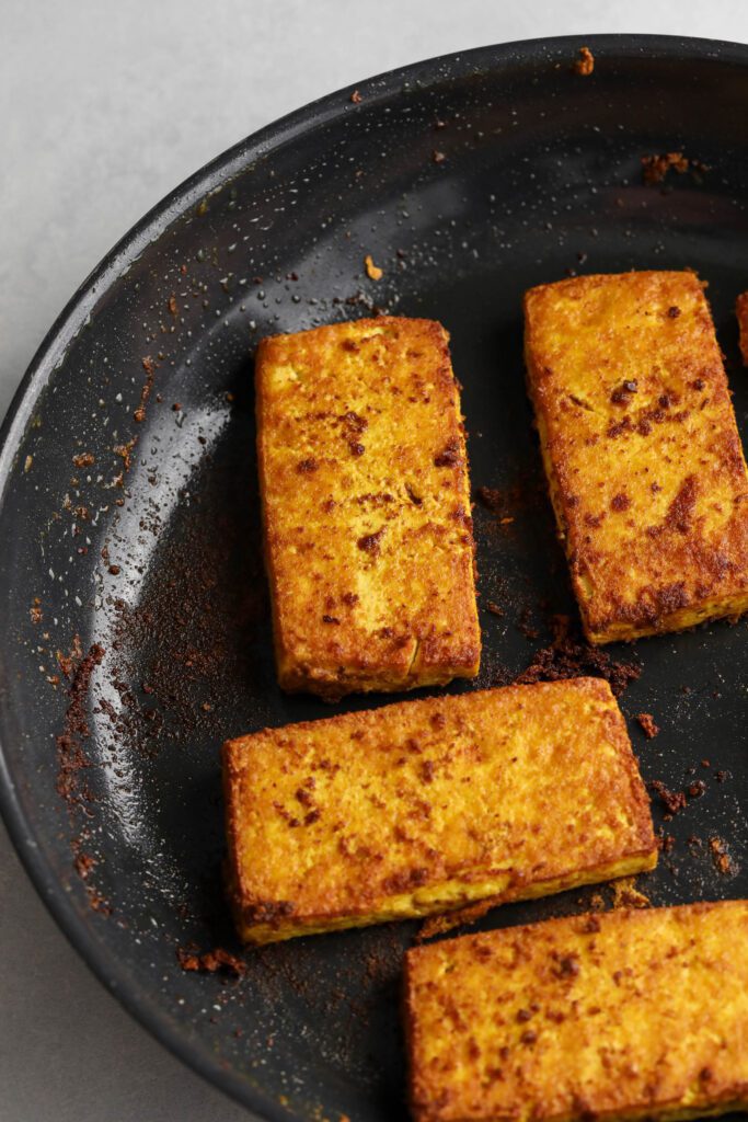 breakfast tofu sliced browned in pan by Flora & Vino