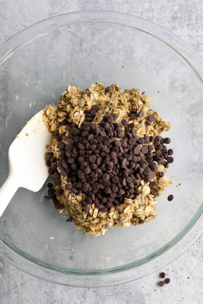 Tahini Chocolate Chip Bliss Ball dough with chocolate chips mixed in plus spatula