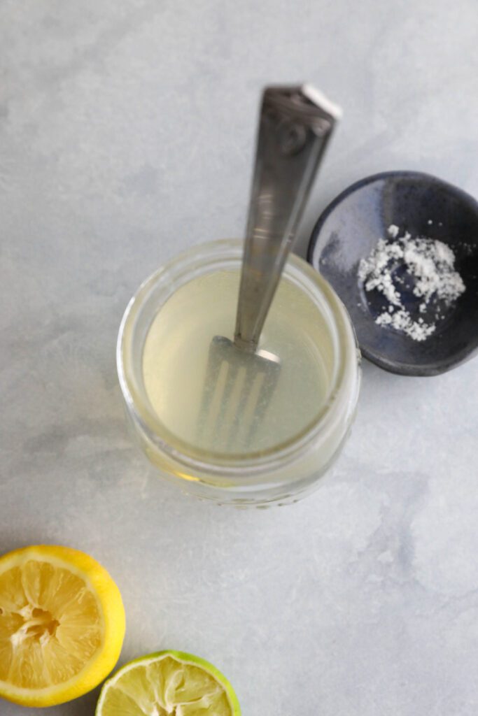 Homemade Electrolyte Water served in mason jar with fork to mix