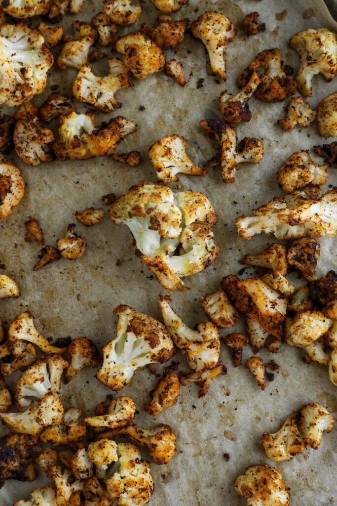 roasted cauliflower on parchment lined baking sheet