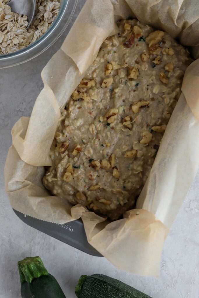 Vegan Zucchini Bread batter in parchment lined loaf pan 
