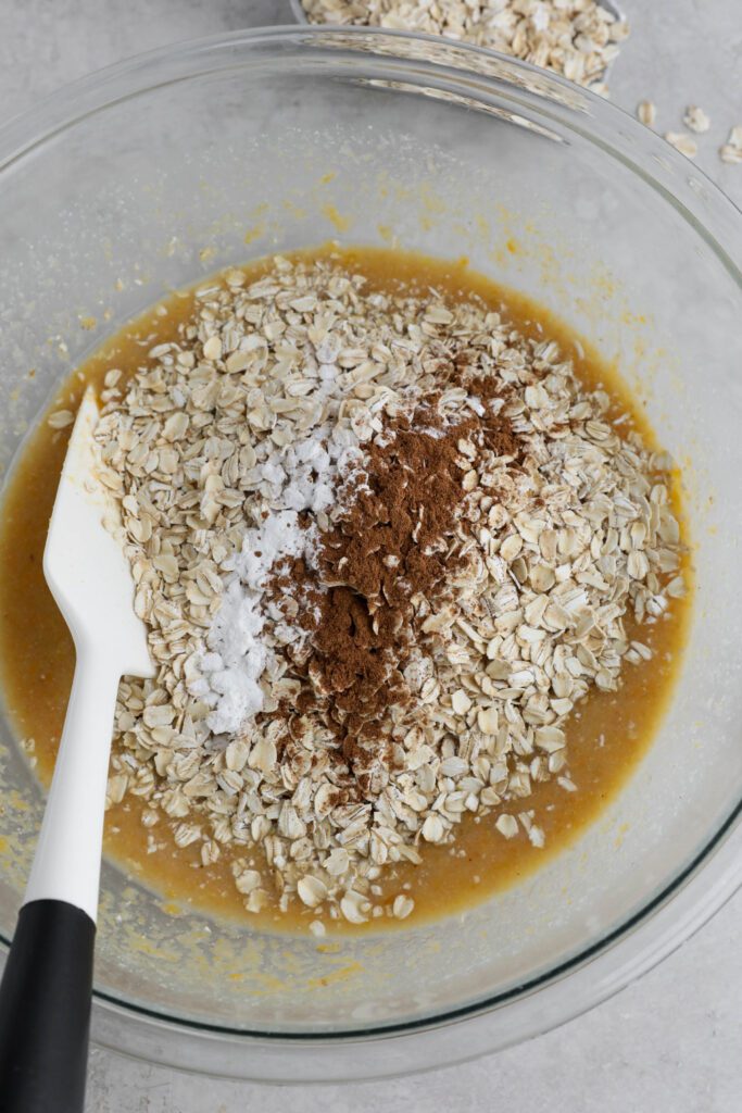 dry ingredients added to wet ingredients for sweet potato pie baked oats in large bowl