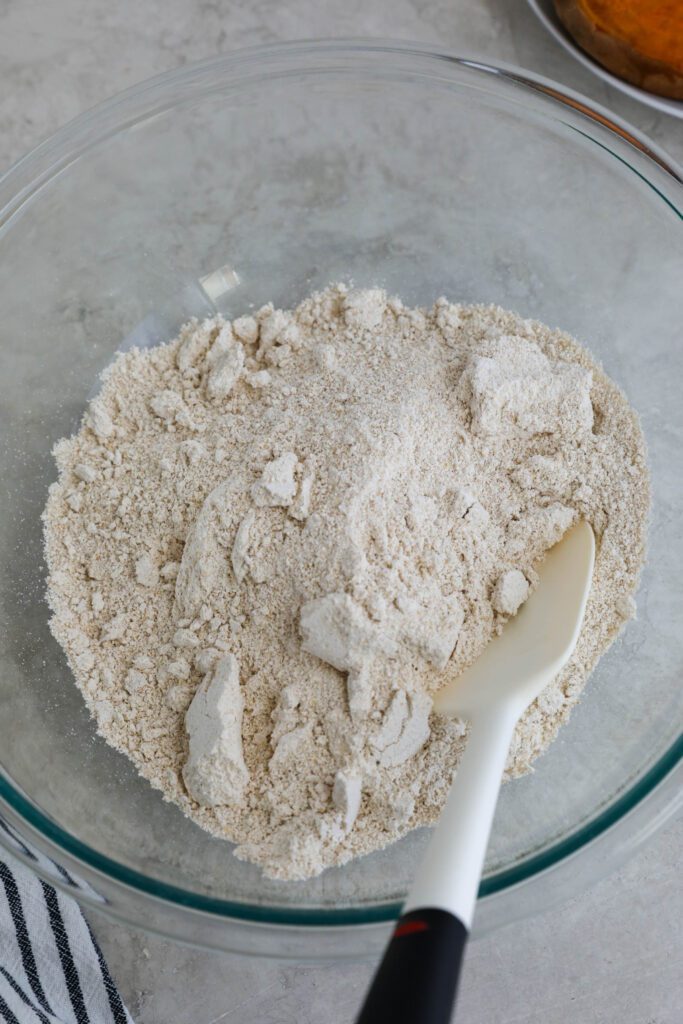 oat flour in glass bowl with spatula