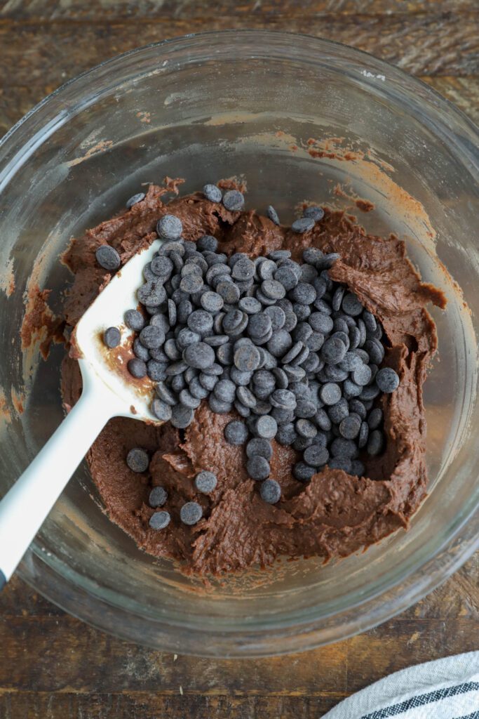 Red Bean Brownie batter in bowl with dark chocolate chips on top with white spatula
