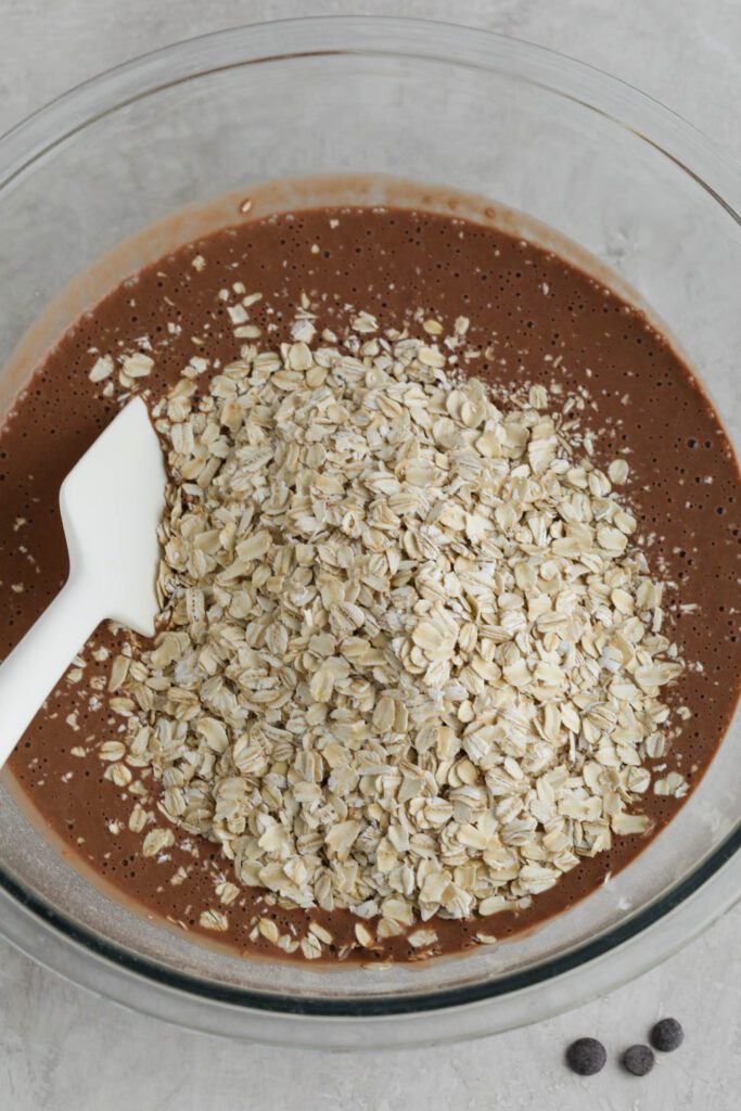ingredients for Red Velvet Baked Oats in mixing bowl with spatula 