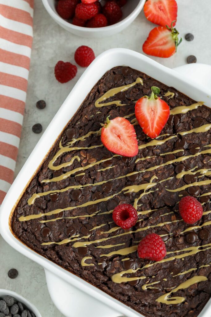 Red Velvet Baked Oatmeal served in baking dish topped with red berries and SunButter