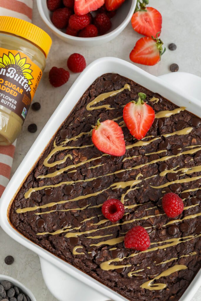 Red Velvet Baked Oatmeal served in baking dish topped with red berries and SunButter 