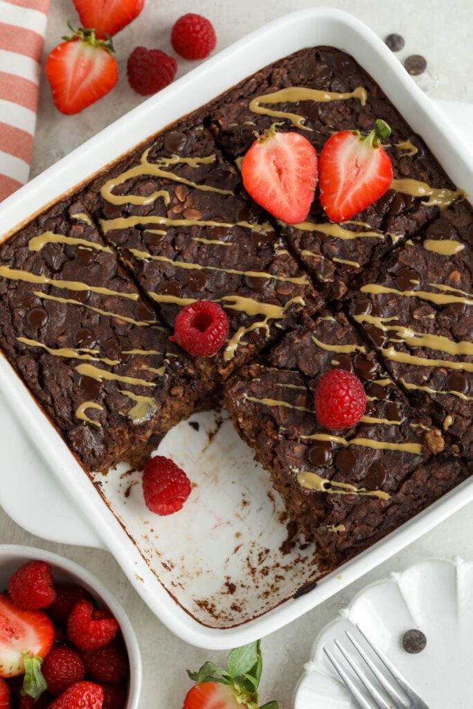 Red Velvet Baked Oatmeal served in baking dish topped with red berries and SunButter 