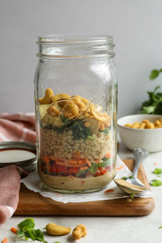 Thai Mason Jar Salads on board with cashews and cilantro in background 