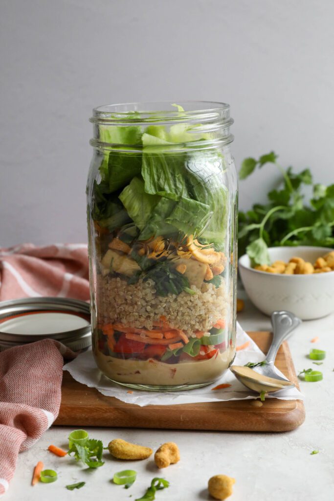 Thai Mason Jar Salads on board with cashews and cilantro in background 