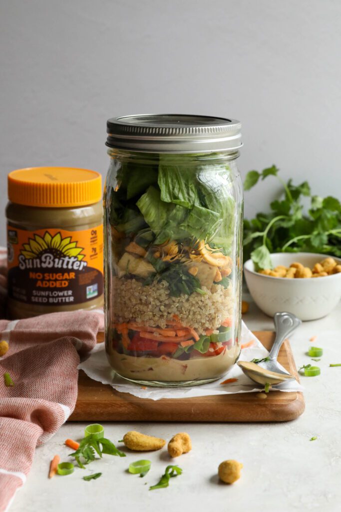 Thai Mason Jar Salads on board with cashews and cilantro in background 