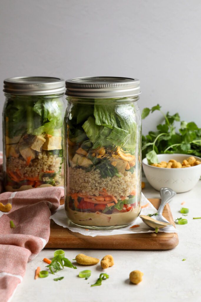 Thai Mason Jar Salads on board with cashews and cilantro in background 