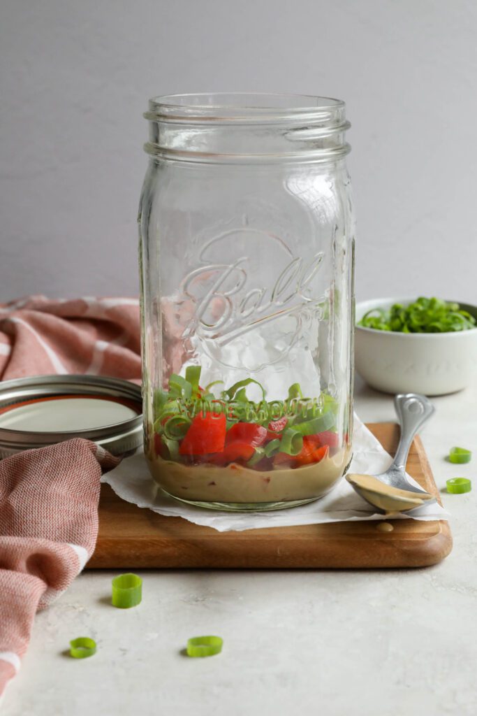 SunButter dressing in mason jar with bell pepper and green onion