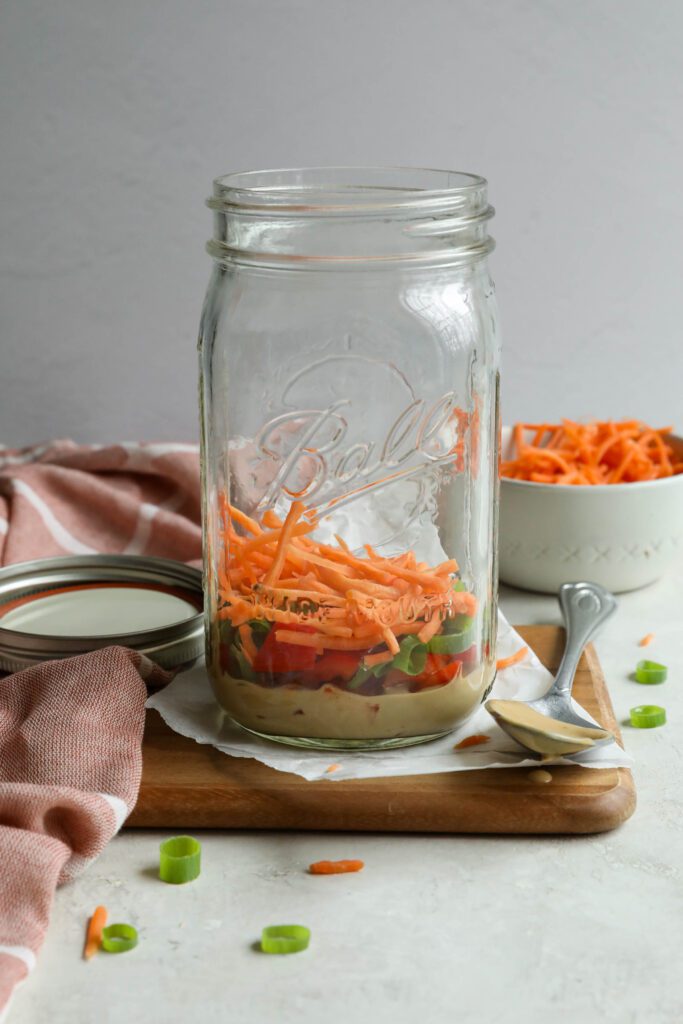 SunButter dressing in jar with bell pepper, green onion, and carrots