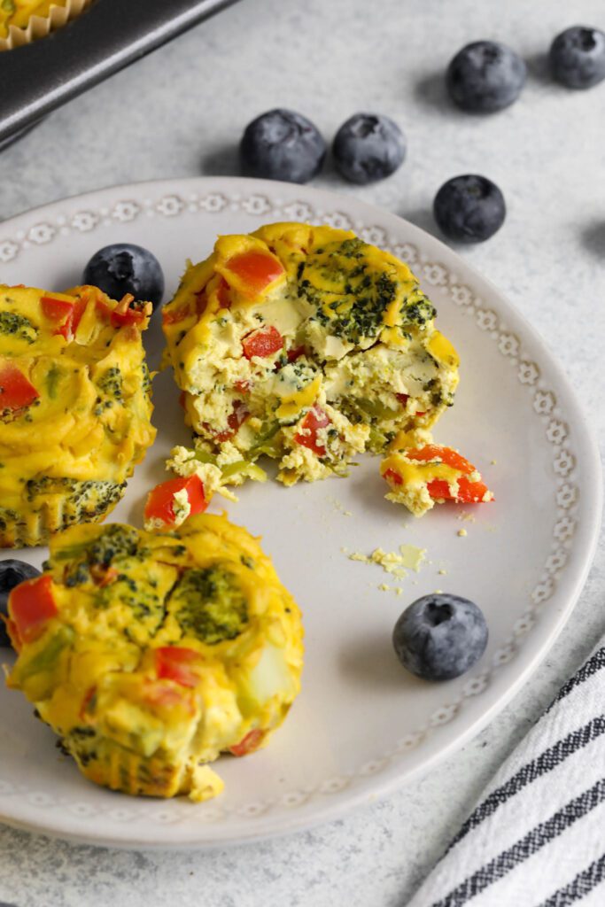 Tofu "Egg" Cups served on white plate with fork and blueberries with glass of orange juice