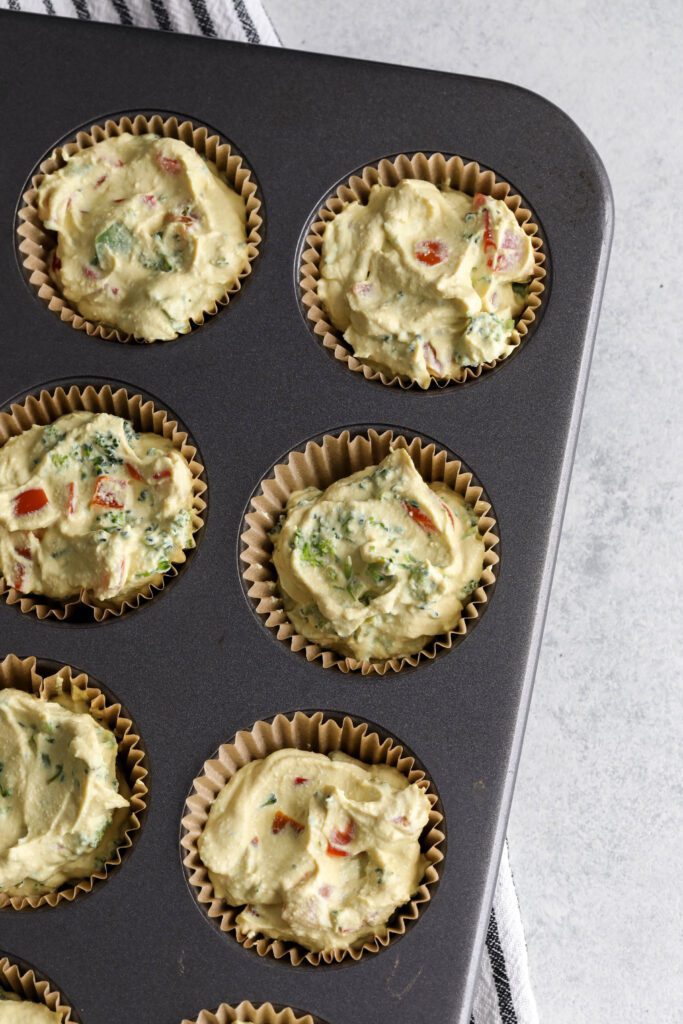 tofu egg cup batter in muffin liners in muffin tin 