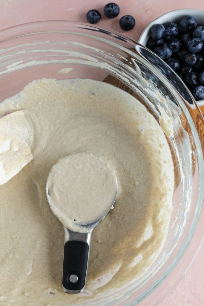 Vegan Applesauce Waffle batter in bowl with 1/2 cup scoop