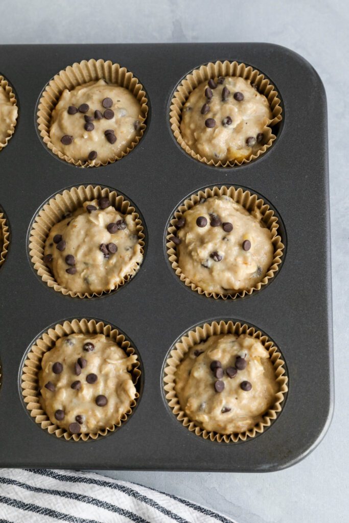 Banana Oatmeal Chocolate Chips Muffin batter in muffin tins