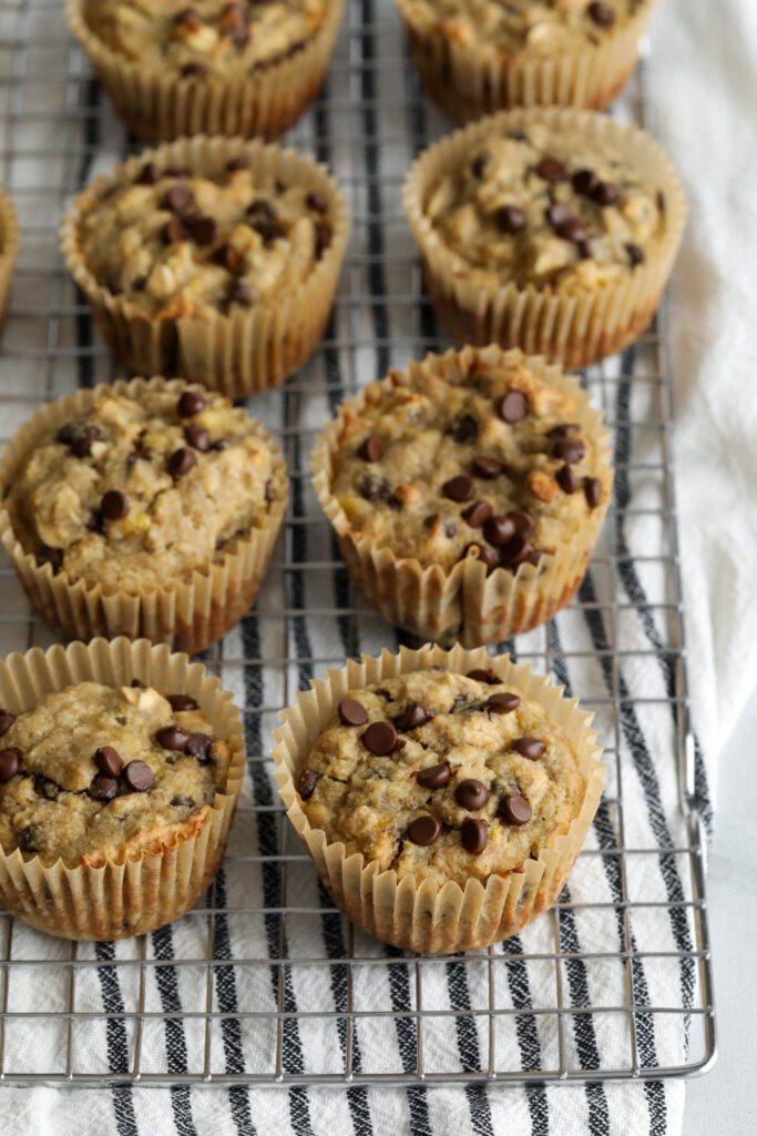Banana Oatmeal Chocolate Chips Muffins on cooling rack on blue and white striped towel
