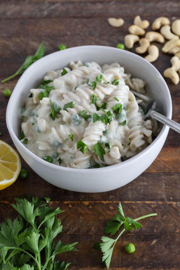 Cauliflower Cashew Alfredo served in bowl with fork topped with parsley