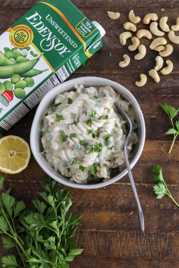 Cauliflower Cashew Alfredo served in bowl with fork topped with parsley