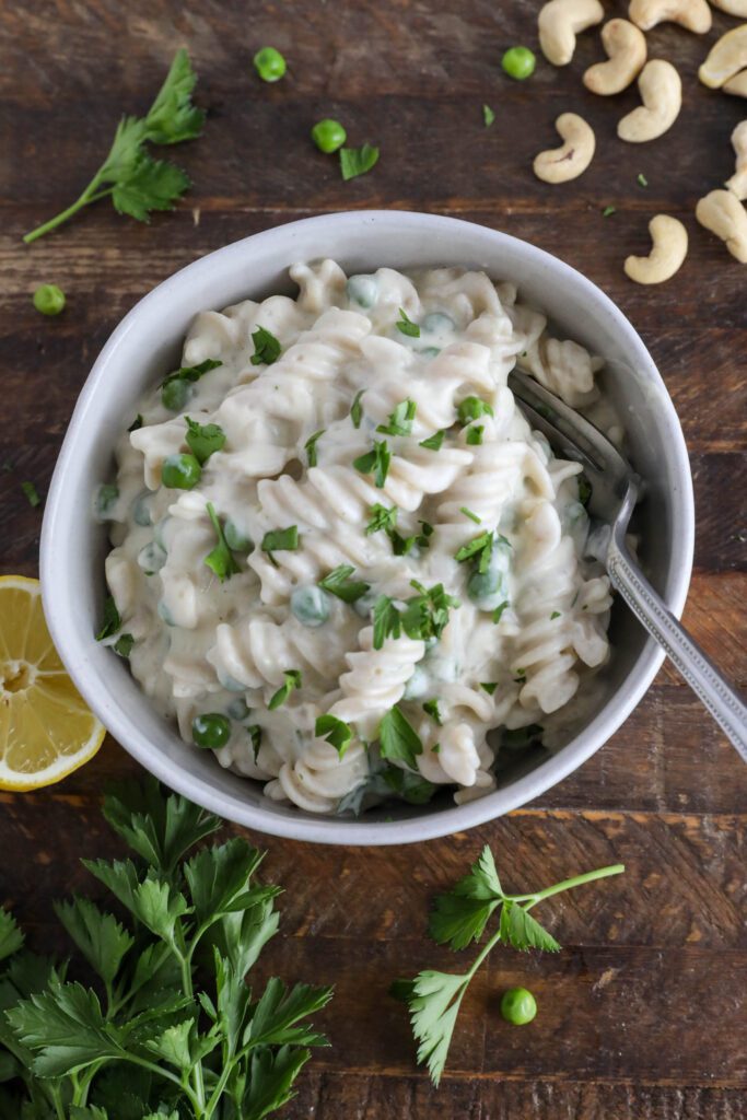 Cauliflower Cashew Alfredo served in bowl with fork topped with parsley