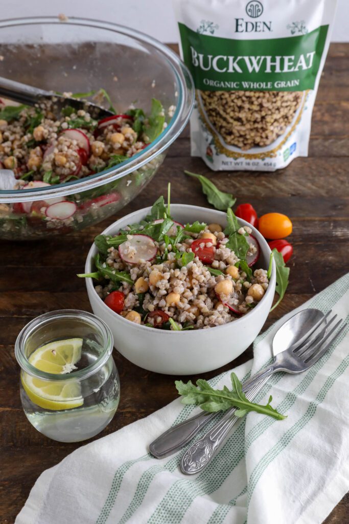 Spring Buckwheat Tabbouleh in bowl with arugula and cherry tomatoes on the side