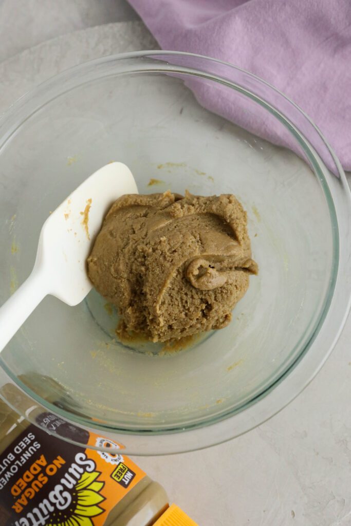 filling for SunButter Chocolate Easter Eggs mixed in glass bowl with spatula 