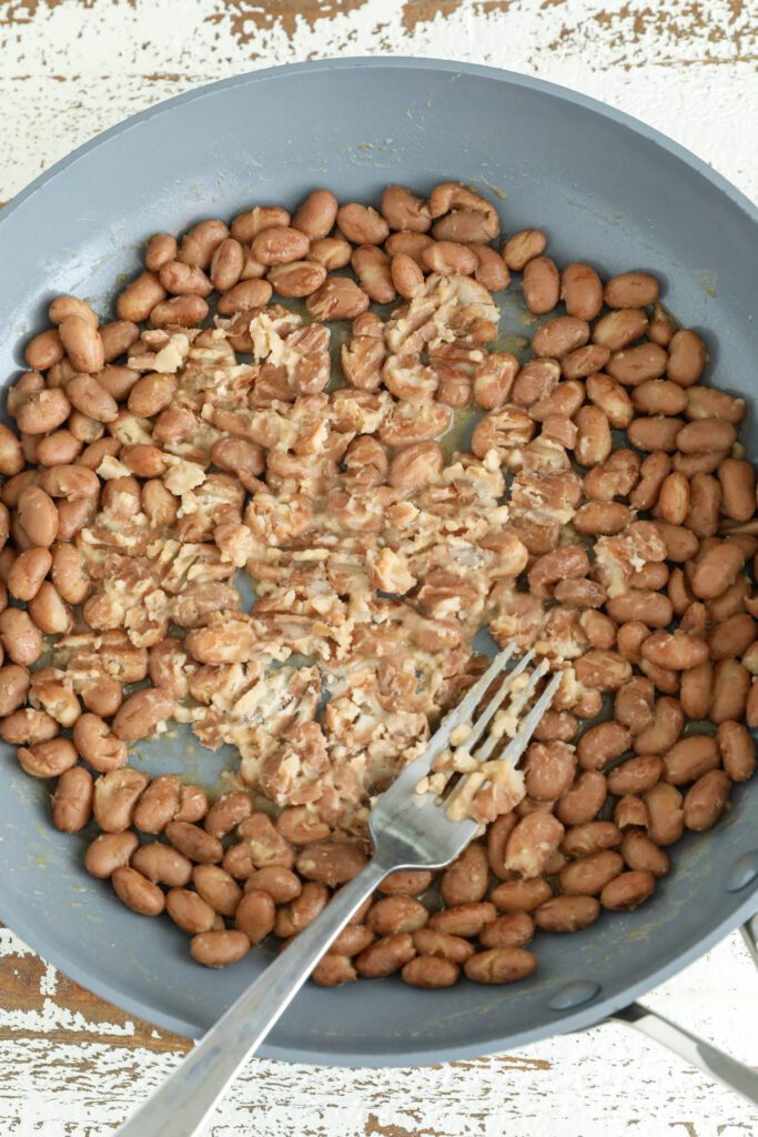 refried beans smashed with pan in fork 