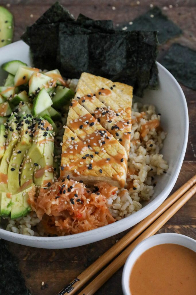 Vegan Viral "Salmon" Bowl served in a bowl with chopsticks and black and white sesame seeds