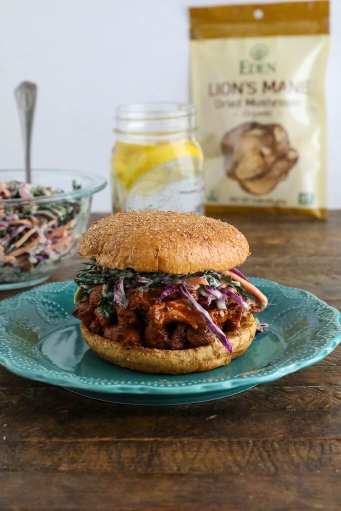 BBQ Lion's Mane Mushroom Sandwich served on blue plate with tahini slaw