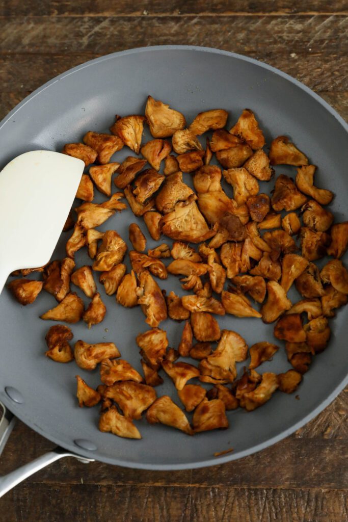 BBQ Lion's Mane Mushrooms sautéed in pan with spatula 
